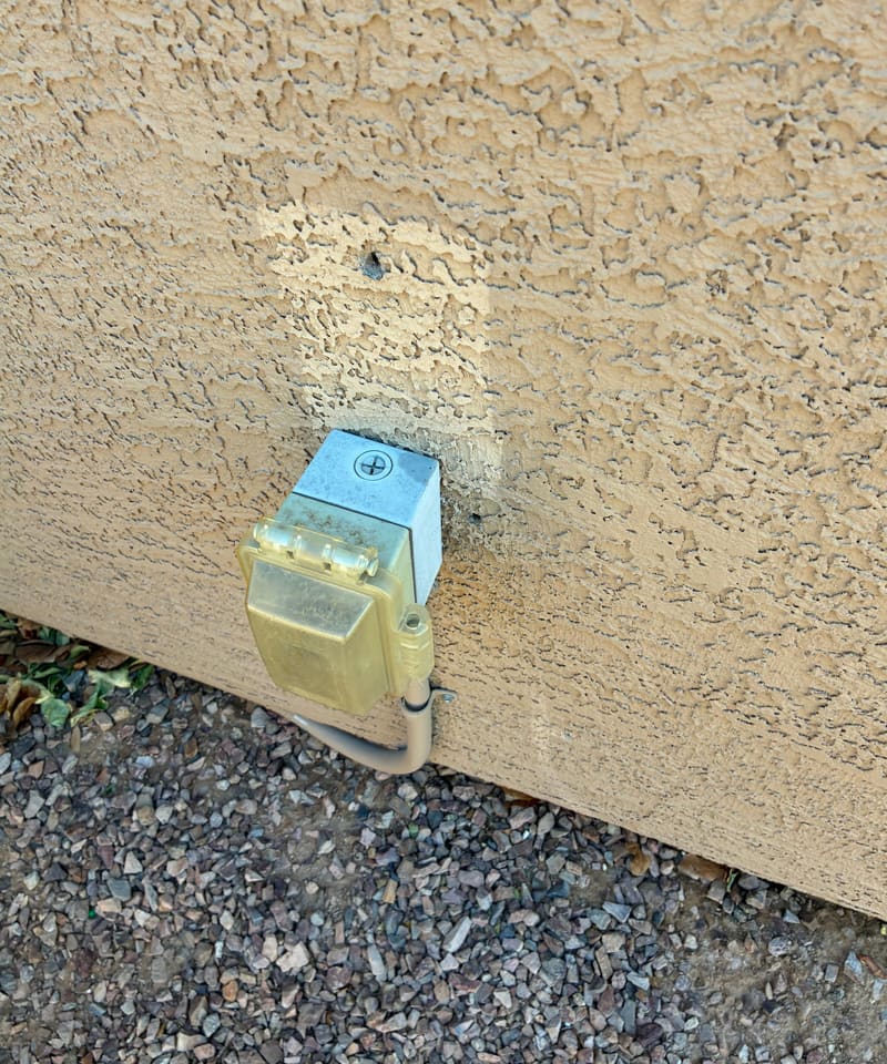 Exterior outlet cover on a stucco wall, a common entry point we check.